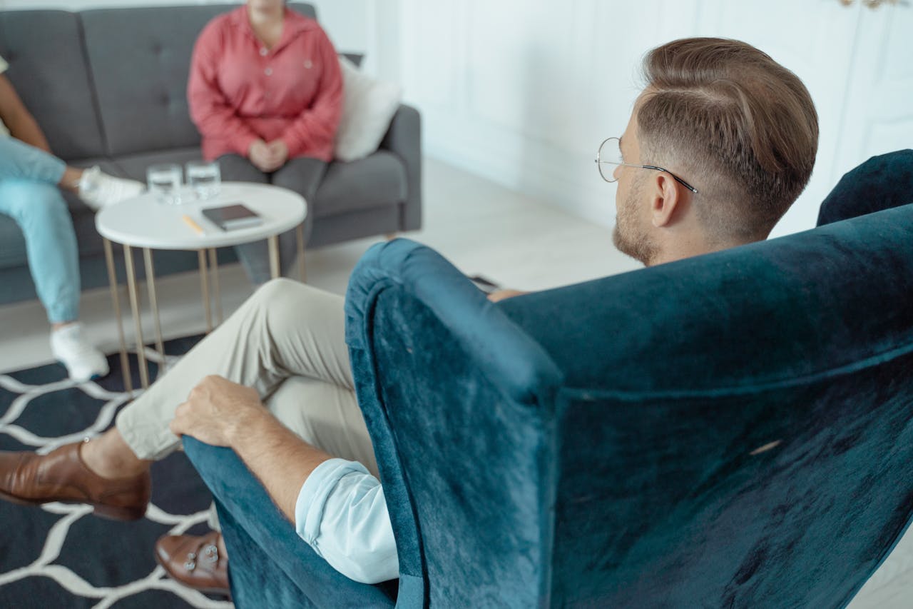 The Art of Drawing Readers In: Your attractive post title goes here A man having a counseling session with a therapist in a modern office setting.